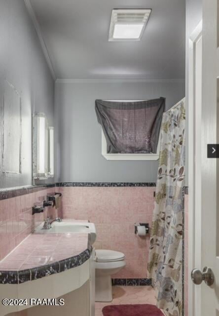 bathroom featuring vanity, ornamental molding, tile walls, and toilet