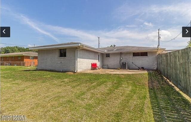 rear view of property with a patio area and a lawn