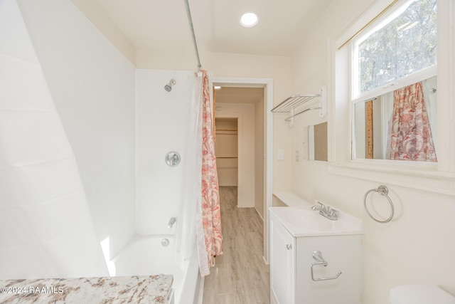 full bathroom featuring shower / bathtub combination with curtain, toilet, vanity, and hardwood / wood-style flooring