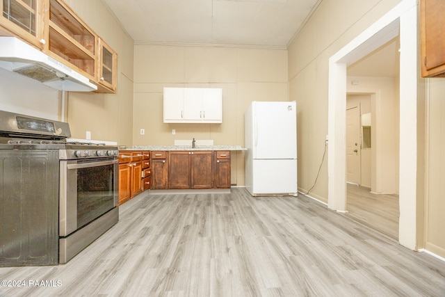 kitchen featuring ornamental molding, sink, white refrigerator, light hardwood / wood-style flooring, and stainless steel gas stove