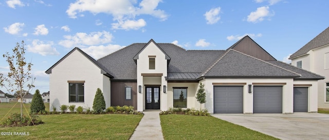 view of front of property with a garage and a front lawn