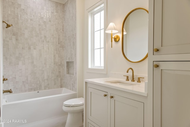 full bathroom with tile patterned floors, vanity, tiled shower / bath combo, and toilet