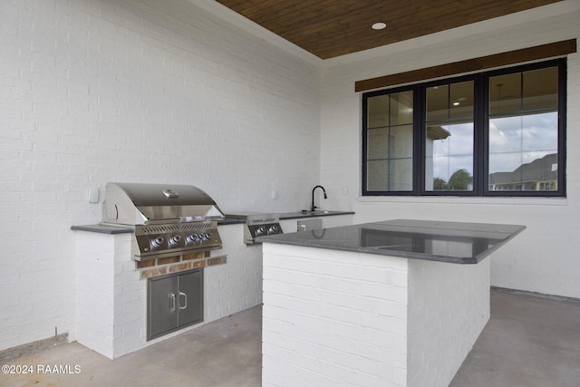 view of patio / terrace featuring area for grilling, sink, and an outdoor kitchen