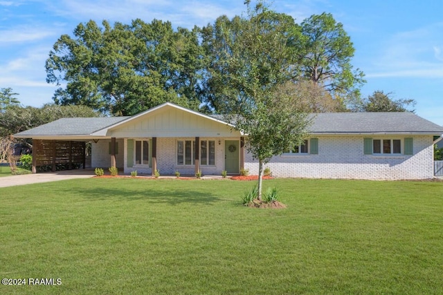 ranch-style home with a front yard, a carport, and covered porch