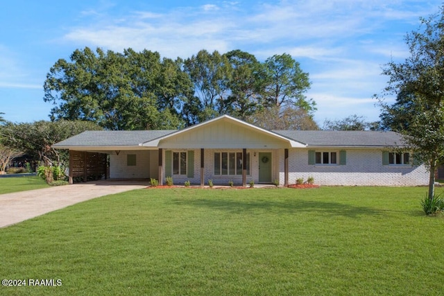 single story home with a carport, covered porch, and a front yard