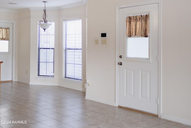 entryway featuring light tile patterned floors and ornamental molding