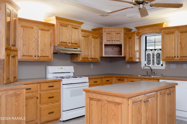 kitchen featuring sink, a center island, white appliances, and ornamental molding