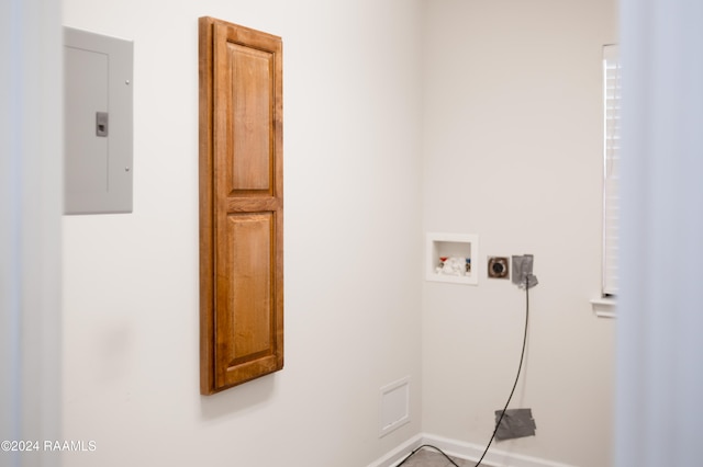 clothes washing area featuring electric panel, hookup for a washing machine, cabinets, and hookup for an electric dryer