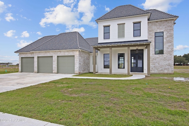 view of front of home featuring a porch, a garage, and a front yard