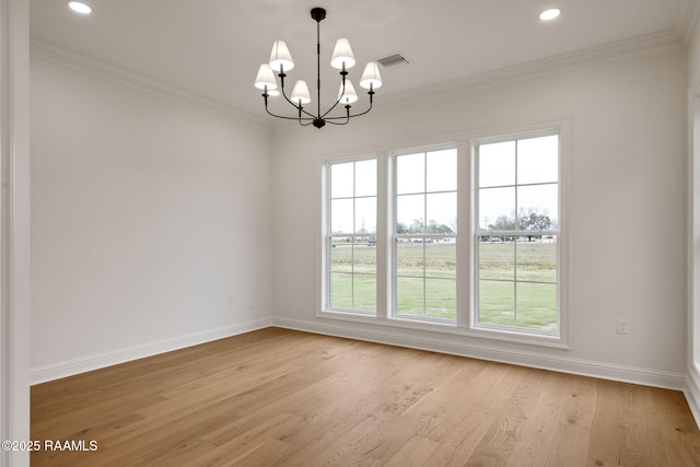 empty room with light hardwood / wood-style flooring, an inviting chandelier, plenty of natural light, and crown molding