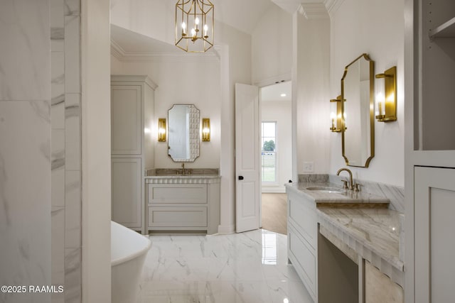 bathroom featuring crown molding, a bathtub, vanity, and an inviting chandelier