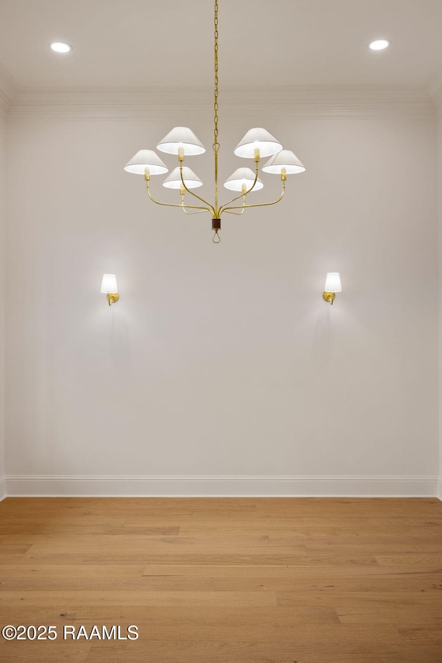 interior details with crown molding, wood-type flooring, and a notable chandelier