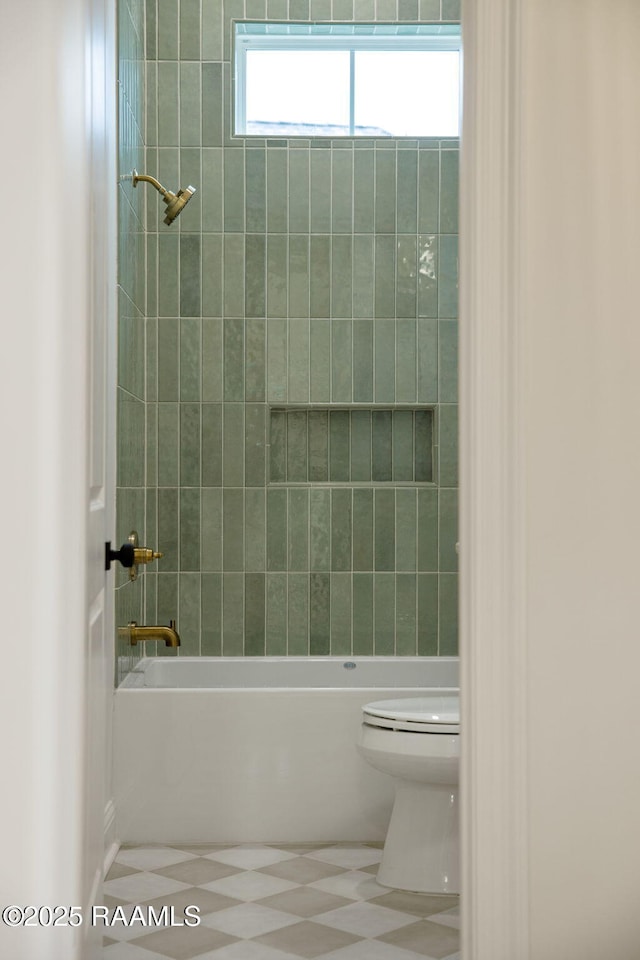 bathroom featuring shower / bathing tub combination and toilet