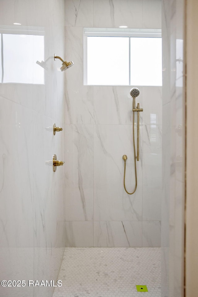 bathroom with tiled shower