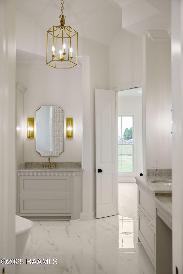 bathroom featuring crown molding, vanity, a chandelier, and lofted ceiling