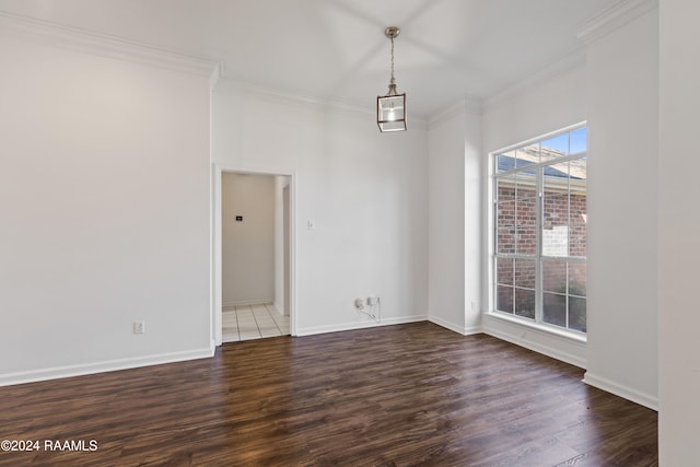 spare room featuring crown molding and hardwood / wood-style floors