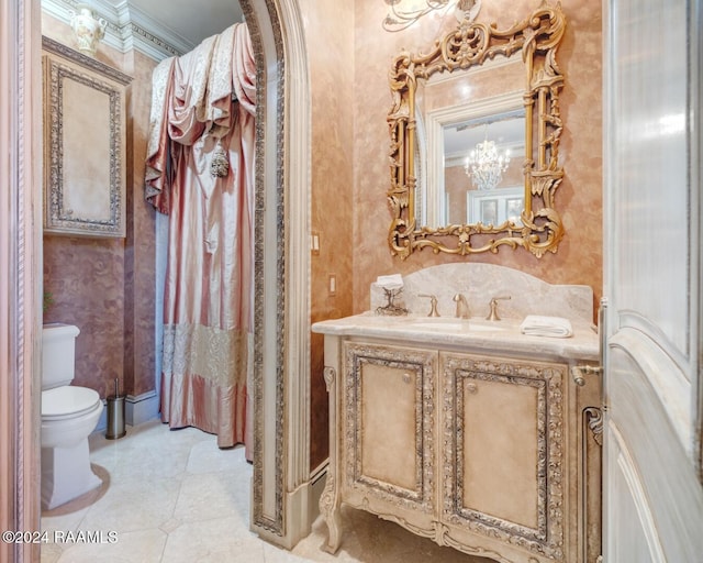 bathroom featuring tile patterned floors, crown molding, vanity, and toilet