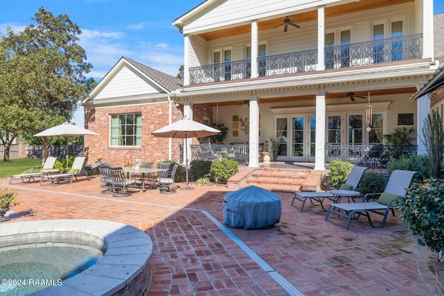 back of house featuring french doors, a patio, a balcony, and ceiling fan