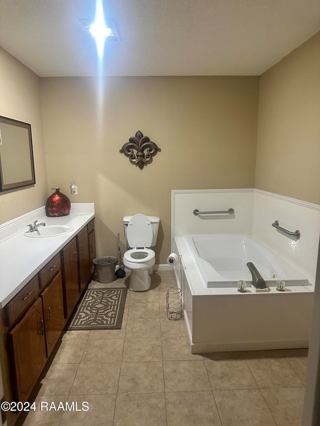 bathroom featuring a tub to relax in, tile patterned flooring, vanity, and toilet