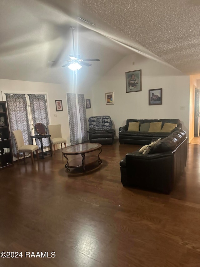 living room with a textured ceiling, dark hardwood / wood-style flooring, ceiling fan, and lofted ceiling