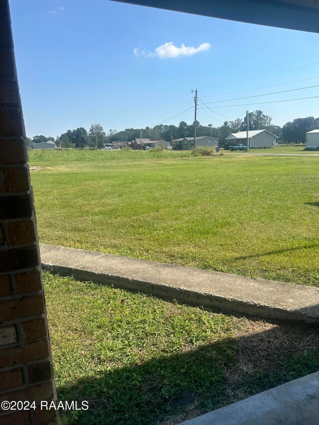 view of yard with a rural view