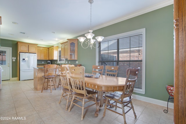 tiled dining space featuring an inviting chandelier and crown molding