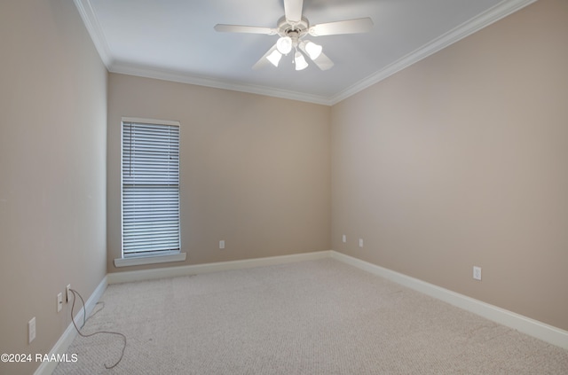 carpeted spare room with ceiling fan and ornamental molding