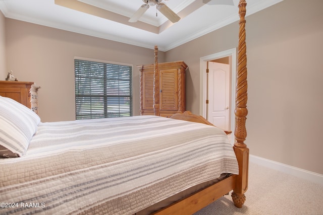 bedroom featuring a raised ceiling, ceiling fan, crown molding, and carpet floors