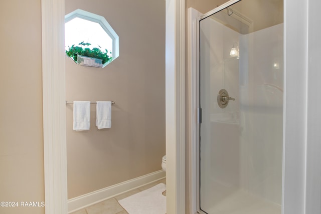 bathroom featuring toilet, tile patterned flooring, and walk in shower