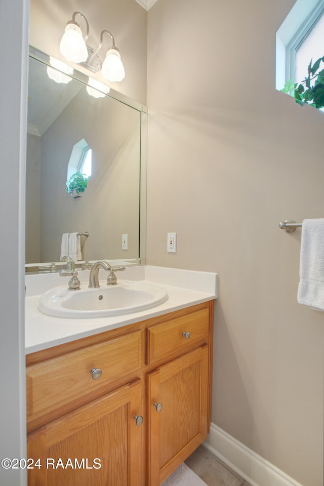 bathroom with vanity and crown molding