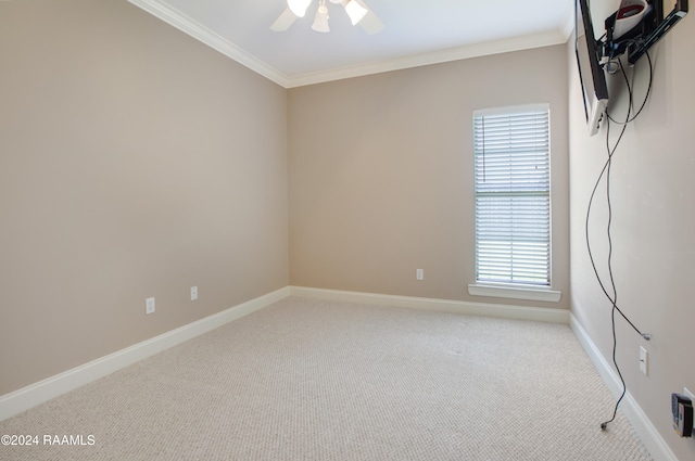 carpeted empty room featuring ceiling fan and ornamental molding