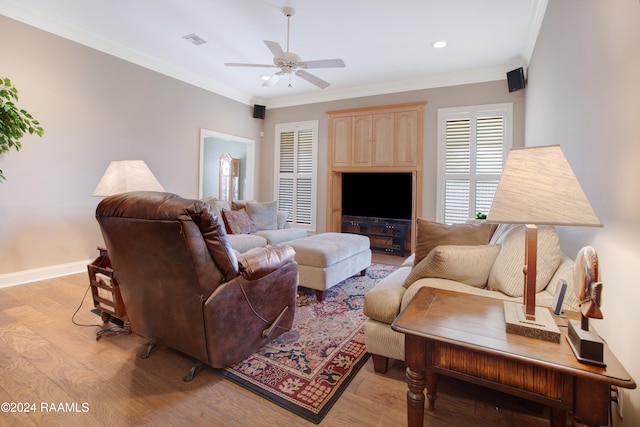 living room featuring ceiling fan, crown molding, and light hardwood / wood-style floors