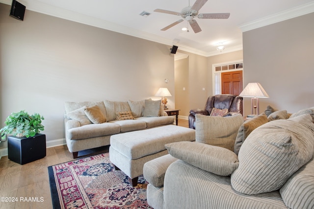 living room with crown molding, ceiling fan, and light hardwood / wood-style floors