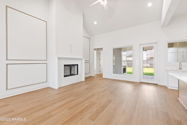407 Sunshine Rise Dr, Broussard, LA 70518 - unfurnished living room featuring ceiling fan, light wood finished floors, a fireplace, high vaulted ceiling, and recessed lighting