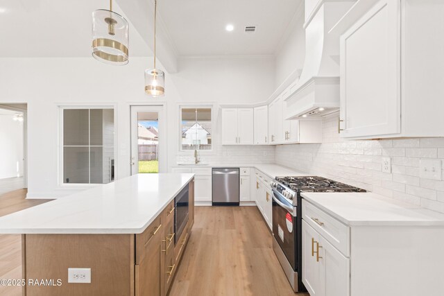 407 Sunshine Rise Dr, Broussard, LA 70518 - kitchen with appliances with stainless steel finishes, custom exhaust hood, white cabinets, light countertops, and crown molding