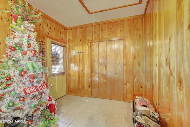 foyer entrance with wooden walls