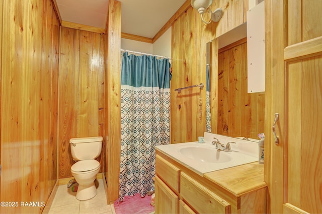 bathroom with tile patterned flooring, crown molding, toilet, wooden walls, and vanity