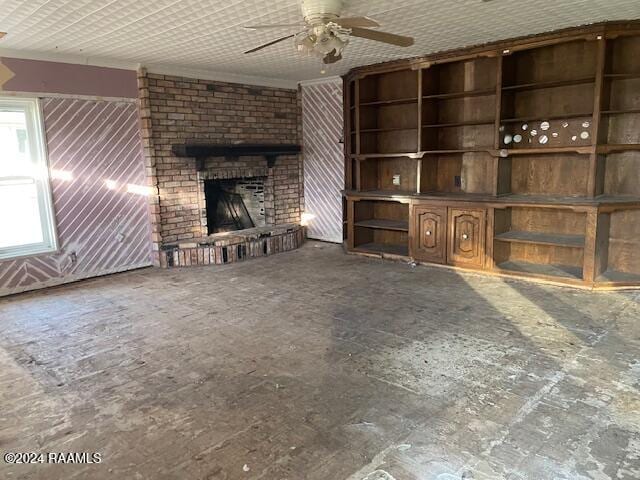 unfurnished living room with ceiling fan and a brick fireplace