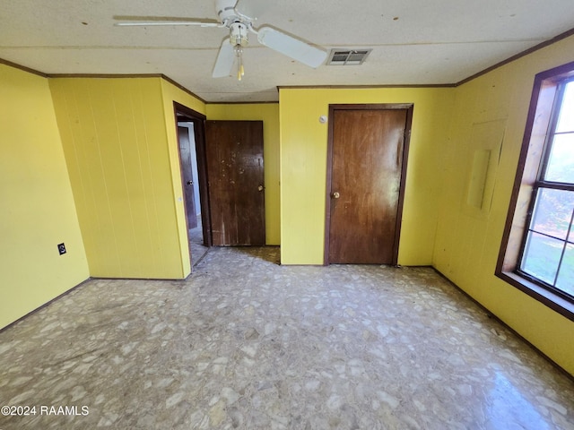 unfurnished bedroom with ceiling fan and crown molding