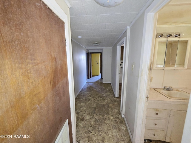 hall with crown molding and sink