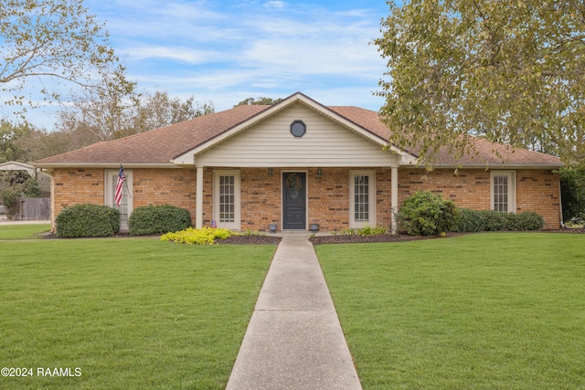 ranch-style home featuring a porch and a front yard