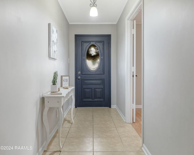 entryway with light tile patterned floors and ornamental molding