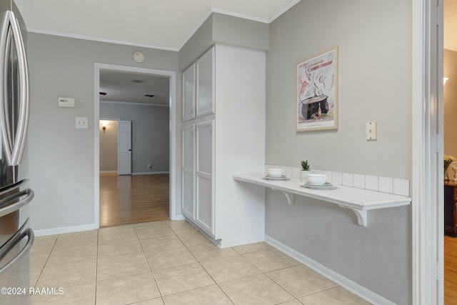 interior space with ornamental molding and hardwood / wood-style flooring