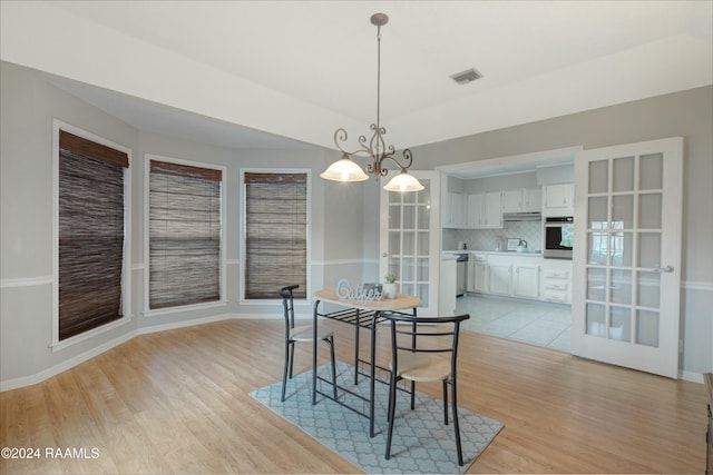 dining room featuring a chandelier and light wood-type flooring