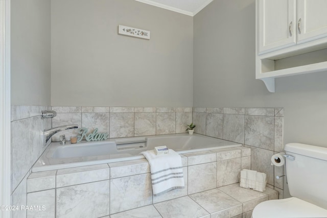 bathroom with a relaxing tiled tub, toilet, and ornamental molding