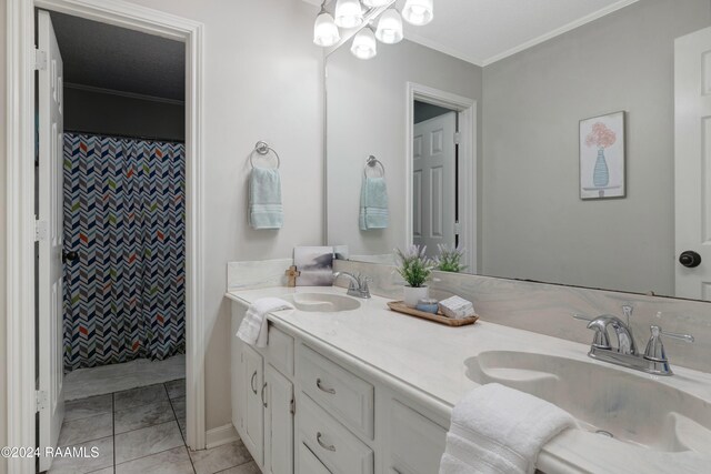 bathroom with tile patterned floors, crown molding, curtained shower, and vanity