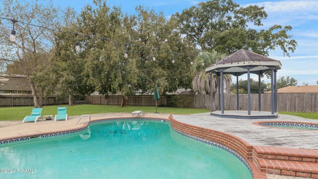 view of pool featuring a gazebo, a yard, and a patio area