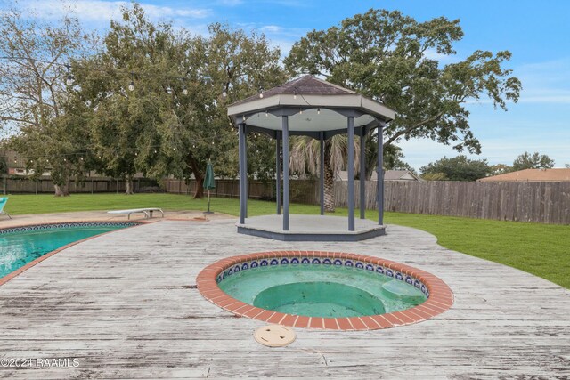 view of swimming pool with a gazebo, a yard, and a diving board