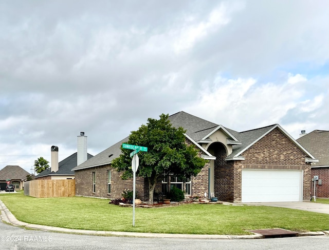 view of front facade featuring a front yard and a garage