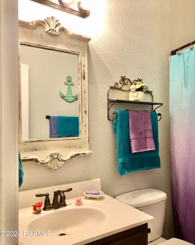 bathroom featuring vanity and toilet